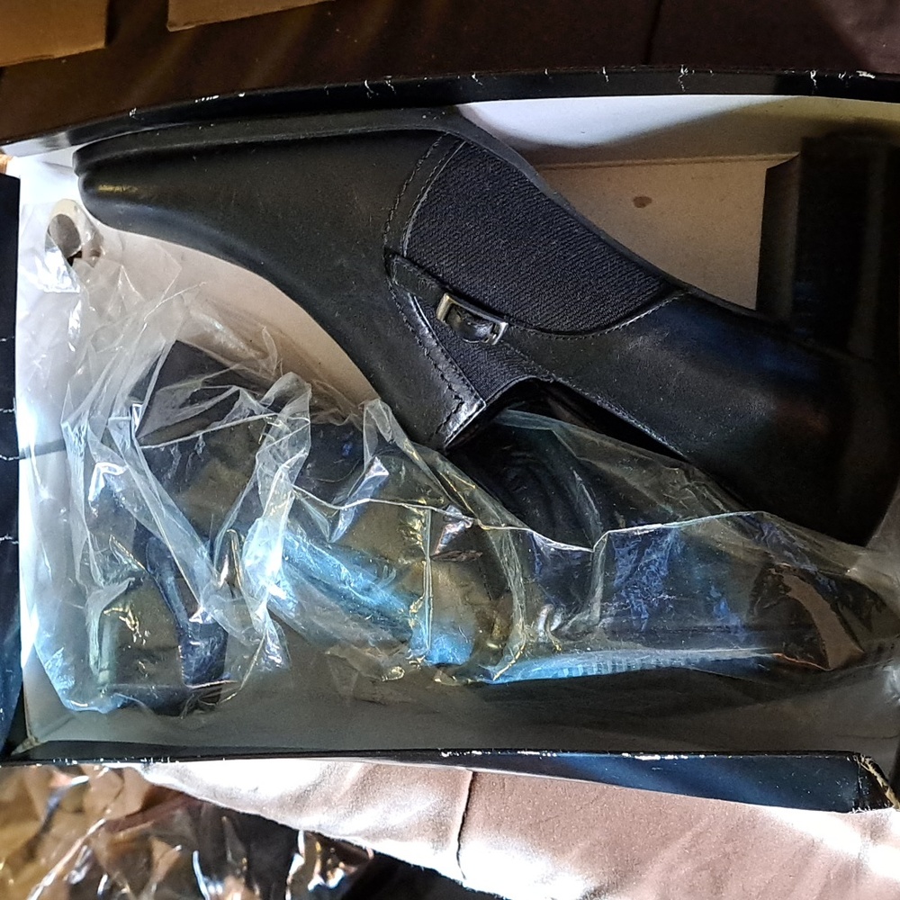 Black leather never been worn shoes. Size 9 and a 1/2.
